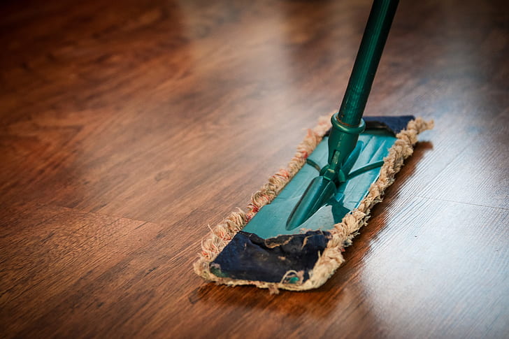 teal and brown floor mop on the floor