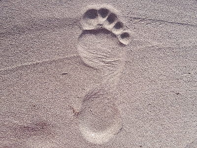 sand footprint during daytime \