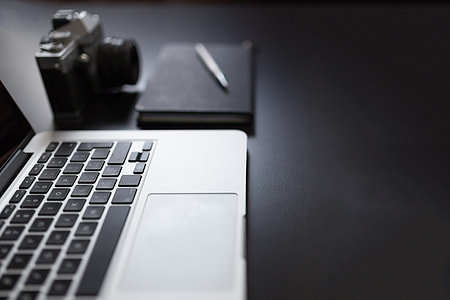 MacBook, Camera and Notepad