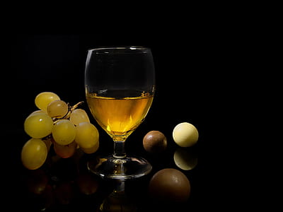 clear wine glass filled with yellow liquid