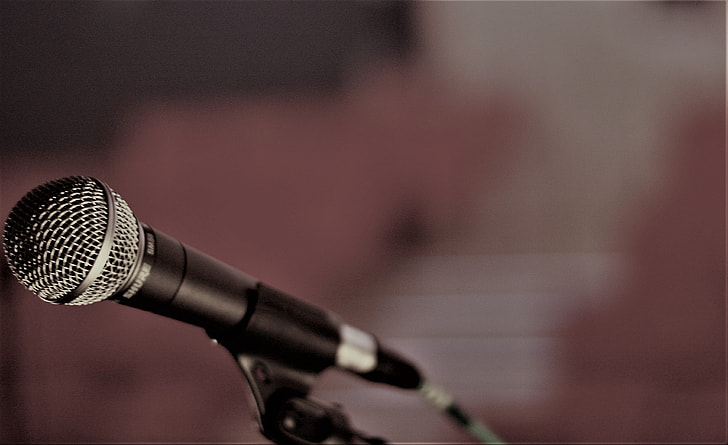 shallow focus photography of black microphone on holder