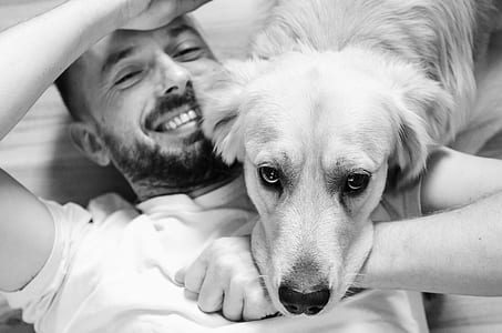 grayscale photo of man with dog