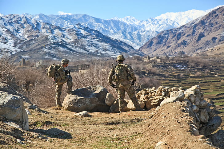 two soldiers on rocky ground during daytime