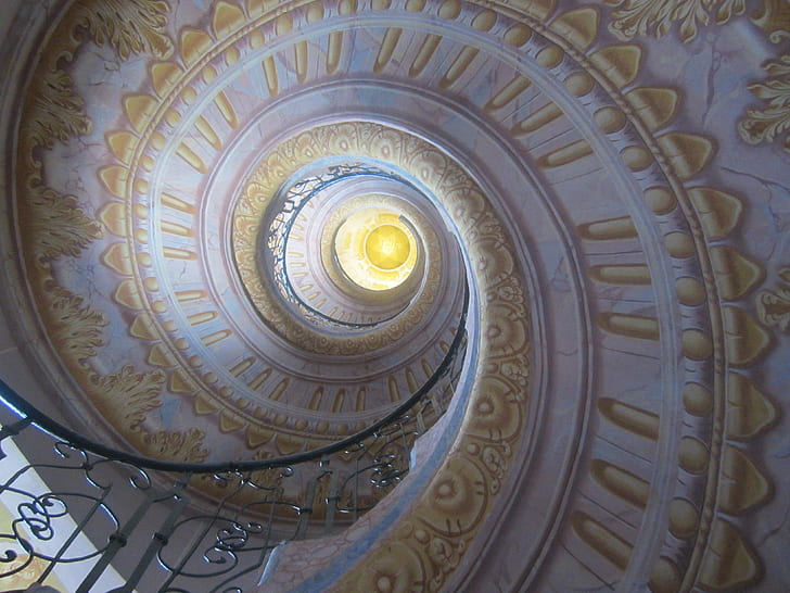 low angle of white and yellow floral spiral staircase ceiling
