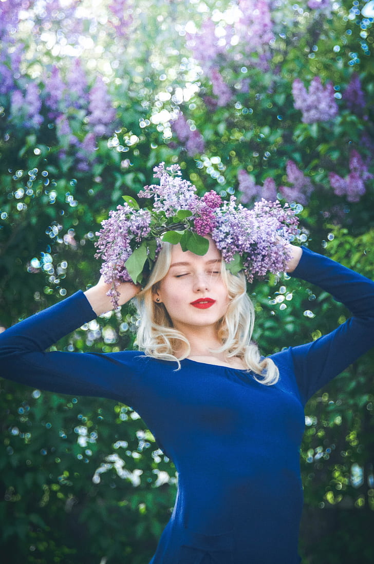 woman wearing blue long-sleeved shirt with purple flowers