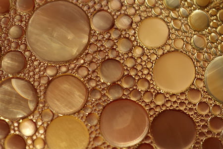 photo of yellow bubble formation on liquid