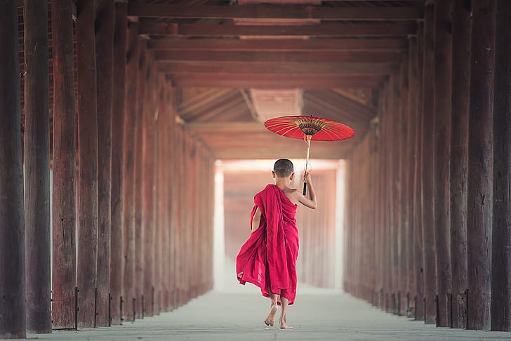 person in pink dress holding red oil paper umbrella