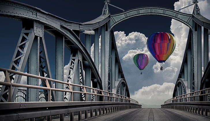 two multicolored hot air balloons near bridge