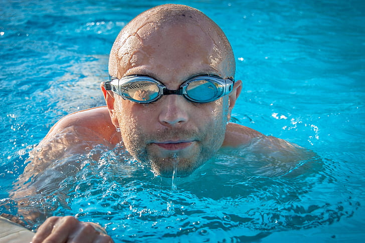 man with goggles in swimming pool