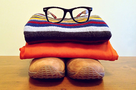 Clothes and reading glasses in pile