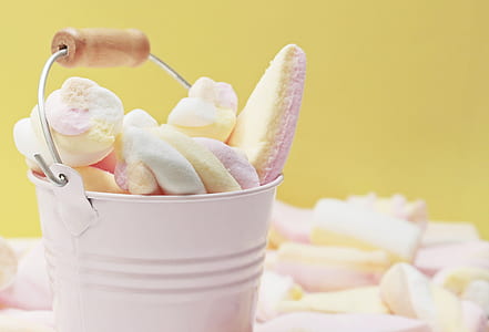 white metal bucket filled with assorted-color mallows