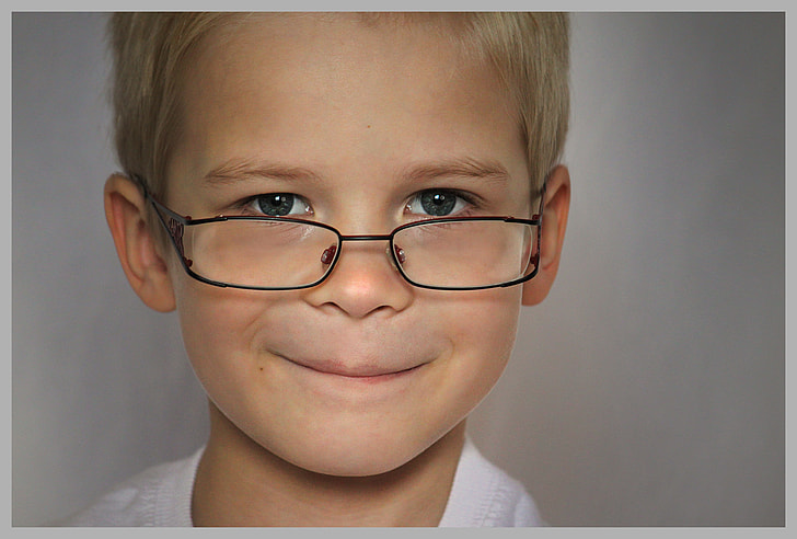 boy wearing eyeglasses and white top