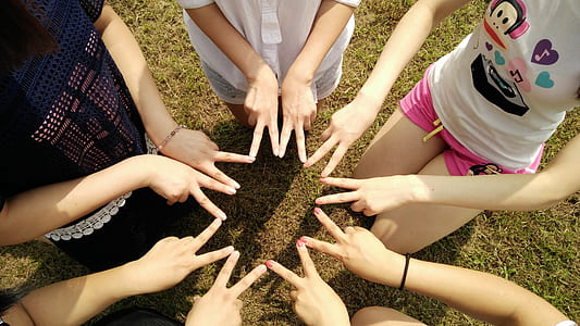 group of girl forming star using fingers