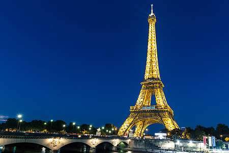 Wide angle night-time shot featuring the iconic Eiffel Tower in Central Paris, France. Image captured with a Canon 6D