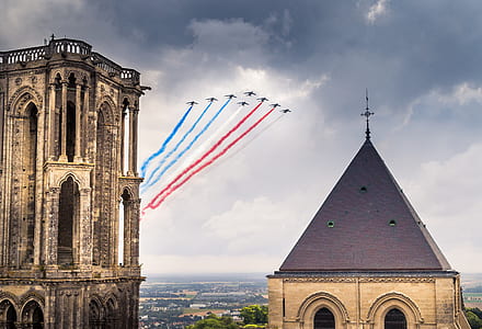 highrise cathedral under jet plane airshow