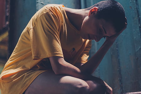 Woman In Yellow Shirt Resting Left Hand On Head