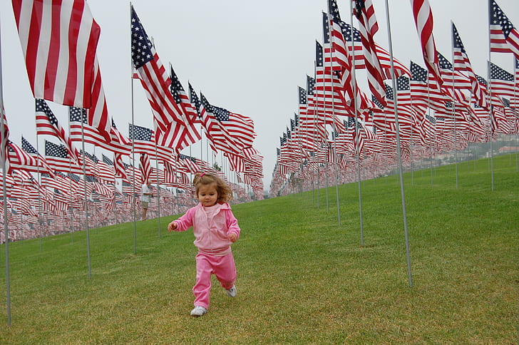 girl running near USA flag lot