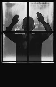 silhouette of toddler standing in front of window