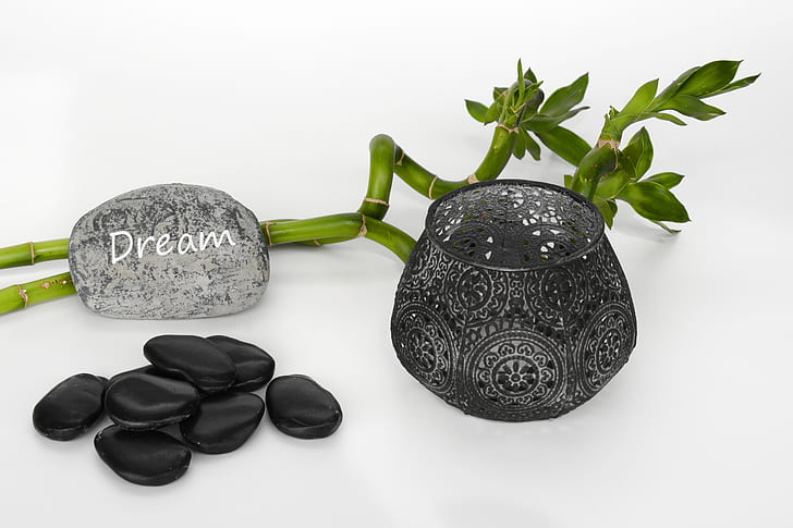 black polished stones and glass vase