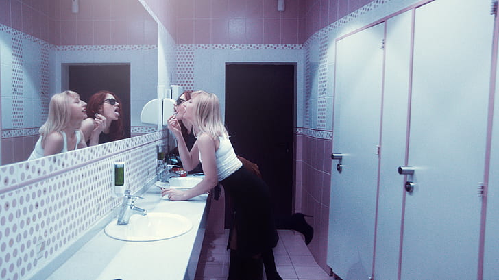 woman standing in front of mirror