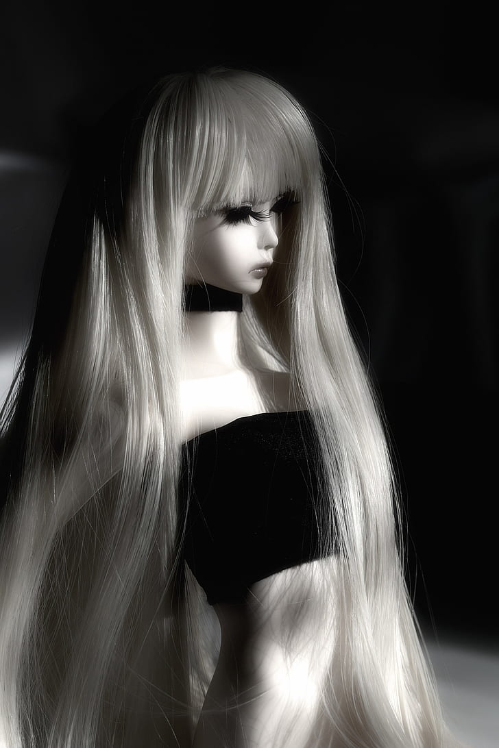 grayscale photo of doll wears black tube shirt