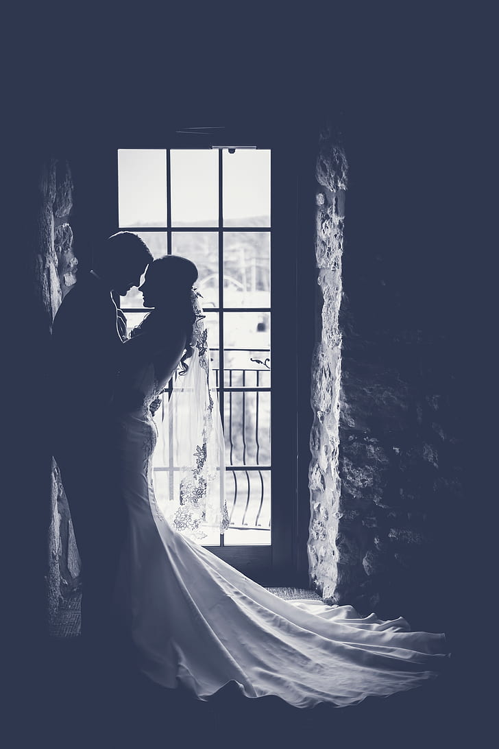 silhouette of couple beside clear glass door