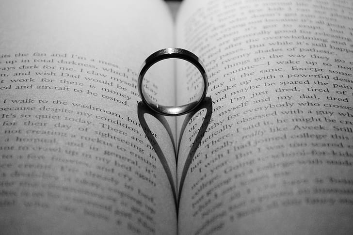 silver-colored ring in the middle of book page center