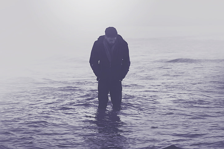 A man standing in the ocean water
