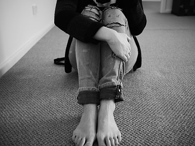 grayscale photo of person wearing denim pants
