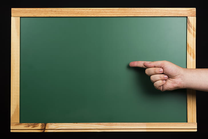person with index finger on chalkboard digital wallpaper
