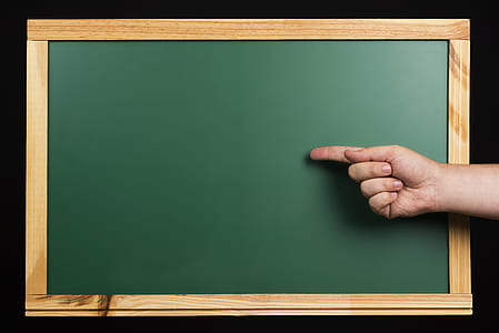 person with index finger on chalkboard digital wallpaper