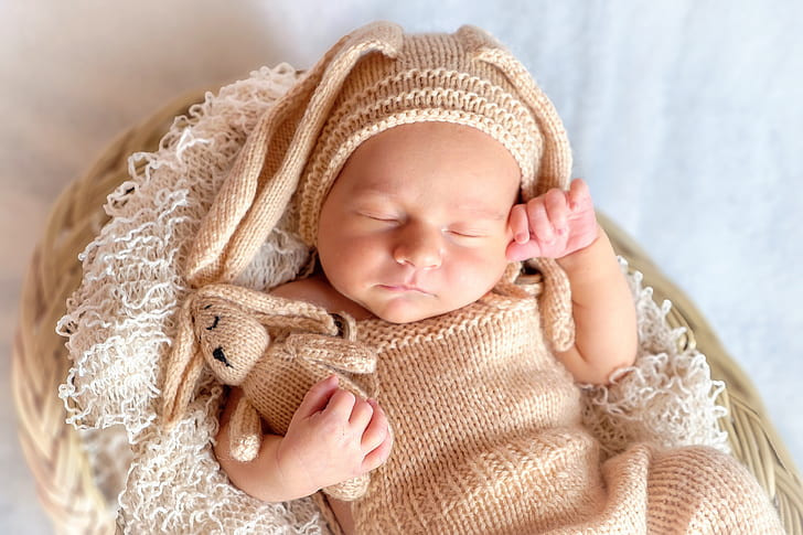 baby wearing brown knitted shirt