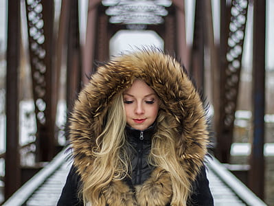 woman wearing brown and black parka hooded jacket