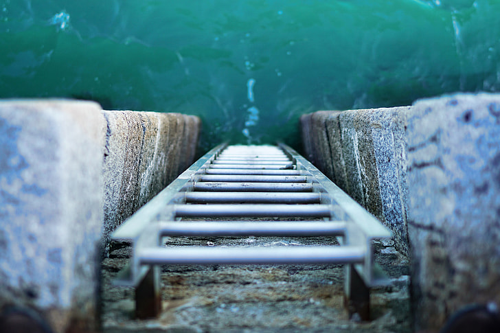Overhead shot of a ladder leading into the ocean water