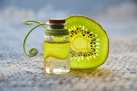 kiwi fruit and clear glass bottle