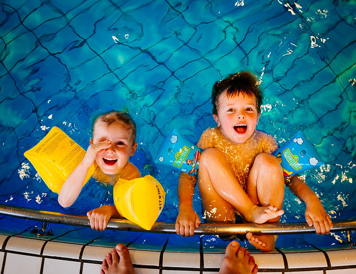 two toddler's on pool smiling