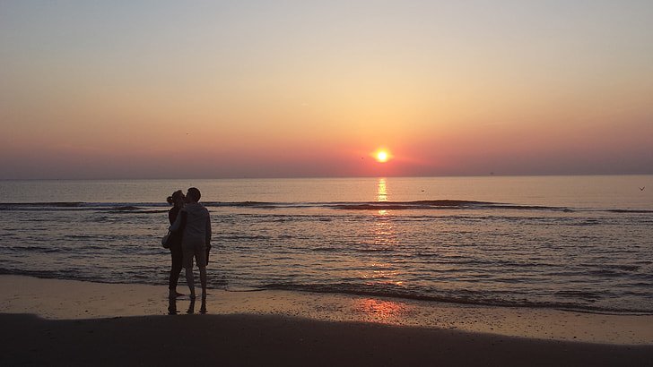 couple at seashore during golden hour