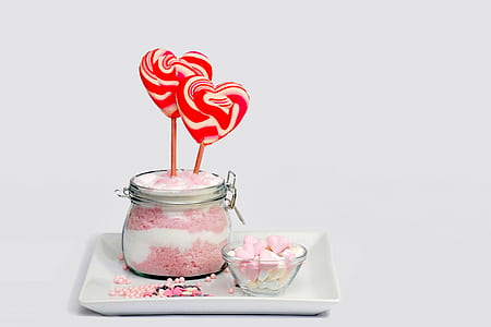 Pink and Grey Heart Shape Lollipop on Clear Glass Jar