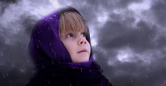 girl in purple hood under grey sky cloudy time
