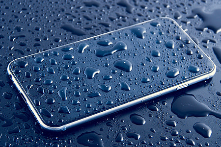 Wet mobile iPhone smartphone with water drops