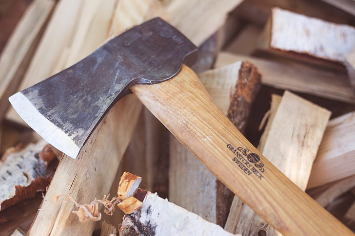 beige wooden handle axe