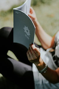 Woman reading a magazine outdoors
