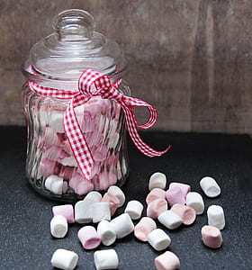 jar of marshmallows on black surface