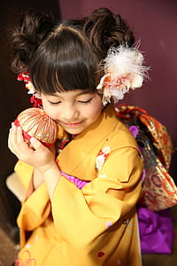 girl wearing yellow floral kimono dress
