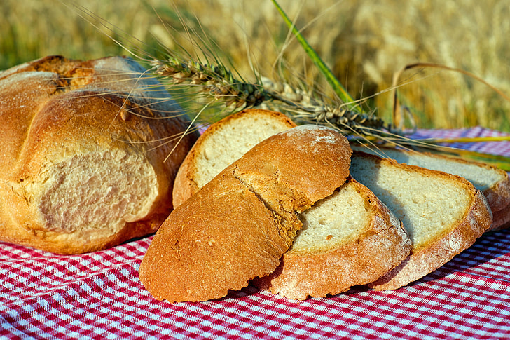 baked bread on red textile