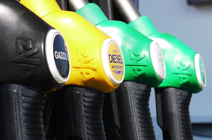 four assorted-colored fuel pump nozzles