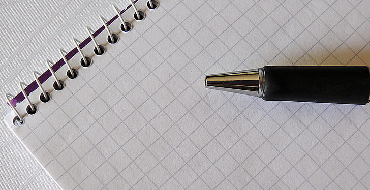 black ballpoint pen on white line paper