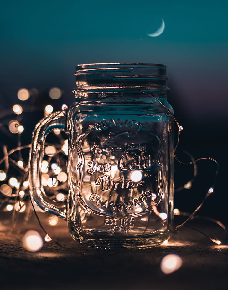 Shallow Focus Photograph of Clear Glass Mason Jar With Fairy Lights