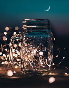 Shallow Focus Photograph of Clear Glass Mason Jar With Fairy Lights