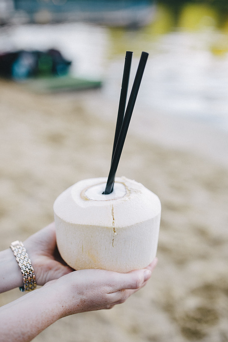 Female holding a fresh coconut